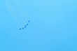 © mr_art - Aerobatics. Planes in the blue sky. Traces of aircraft in the sky. Drawings on the sky.