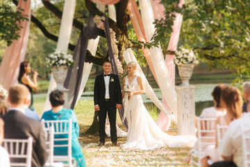 Wedding couple on ceremony outside. beautiful bride and handsome groom. Just married