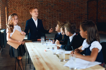 Wall Mural - ginger cheerful boss disscussing serious problems of firm with partners, leadership concept