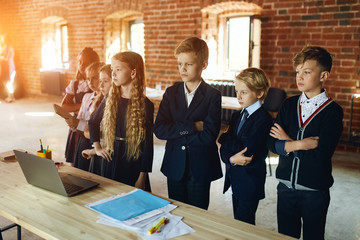 Wall Mural - serious motivated talented ambitious team with clever female leader looking aside, the future of company. loft room