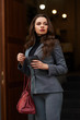 © Dmitry Tsvetkov - Elegant lady in gray suit with red handbag walking or posing against door. Fashion style portrait. Fashionable look