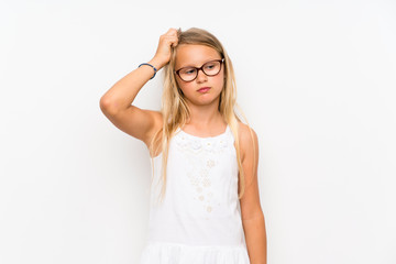little girl over isolated white wall having doubts