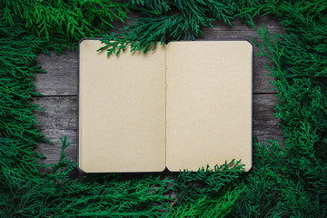 Wall Mural - Christmas green frame from fir branches on a vintage gray board background. Frame of fir branches. Christmas card blank.