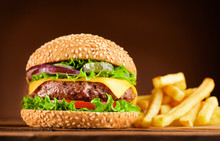 Burger And French Fries On Wooden Table
