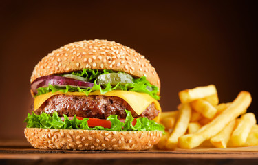 burger and french fries on wooden table