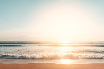 Wall Mural - tropical beach with smooth wave and sunset sky abstract background.