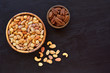 Roasted salted mixed nuts in wooden bowls. Top view with space for text