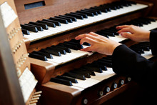 A Woman Playing The Pipe Organ 