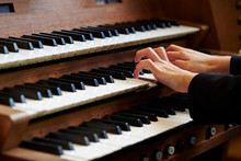 A Woman Playing The Pipe Organ 