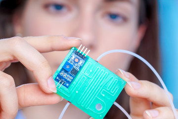 Wall Mural - Girl holding polymers Bio-MEMS biomedical microelectromechanical systems / LOC lab-on-a-chip device (concept design)