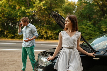 Wall Mural - Couple calling a tow truck on road, car breakdown