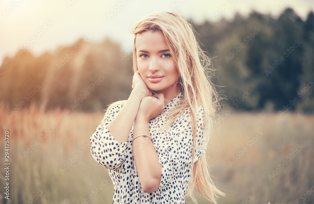 Close Up Portrait of beauty girl with fluttering white hair enjoying nature outdoors, on a field. Flying blonde hair on the wind. Breeze playing with girl's hair. Beautiful young woman face closeup. - obrazy, fototapety, plakaty 
