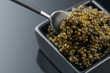 Black Caviar in spoon. High quality real natural sturgeon black caviar close-up. Delicatessen. Texture of expensive luxury fresh caviar, square dish on black. Diet, dieting
