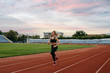© Nomad_Soul - Female runner jogging, training on stadium