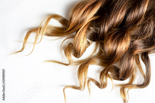 Cuadros en Lienzo long brown curly hair on white isolated background