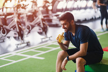 Fitness Handsome Mid Guy Eating Banana After Workout In Fitness Studio