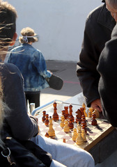 JERUSALEM - MAR 25 2015:Elderly men play backgammon in Mahane Yehuda Market in Jerusalem, Israel. Backgammon is among the oldest known board games, and many variants are played throughout the world.