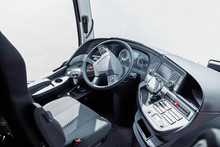 The Driver Cab Of A Bus With A Steering Wheel And Various Devices And Gadgets