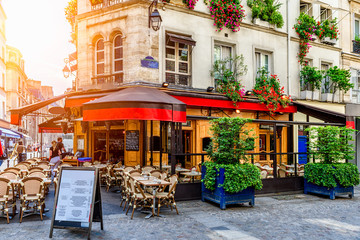 Wall Mural - cozy street with tables of cafe in paris, france. architecture and landmark of paris. cozy paris cit