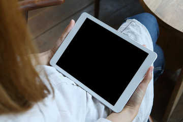 Business woman using tablet on wooden desk