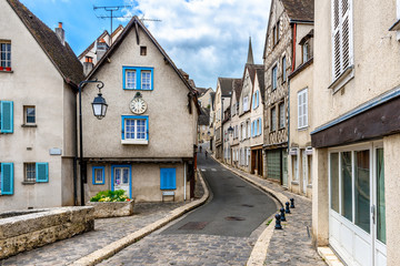 Fototapete - Cozy street with old houses in a small town Chartres, France