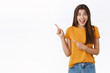 © Cookie Studio - Cheerful, thrilled and amused cute girl taking part awesome giveaway want win trip abroad, pointing upper left corner, smiling amused and look excited camera, standing white background joyful
