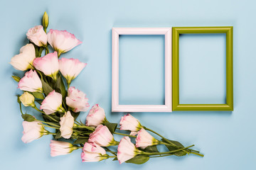 Canvas Print - Empty color frames and flowers eustoma on blue paper background with copy space. Flat lay. Love concept