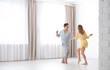 © New Africa - Beautiful young couple dancing in room at home