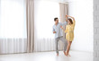 © New Africa - Beautiful young couple dancing in room at home