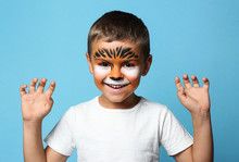 Cute Little Boy With Face Painting On Blue Background