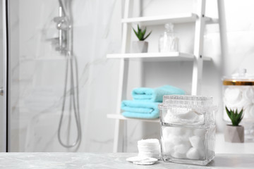 Wall Mural - Cotton pads and balls on light grey marble table in bathroom