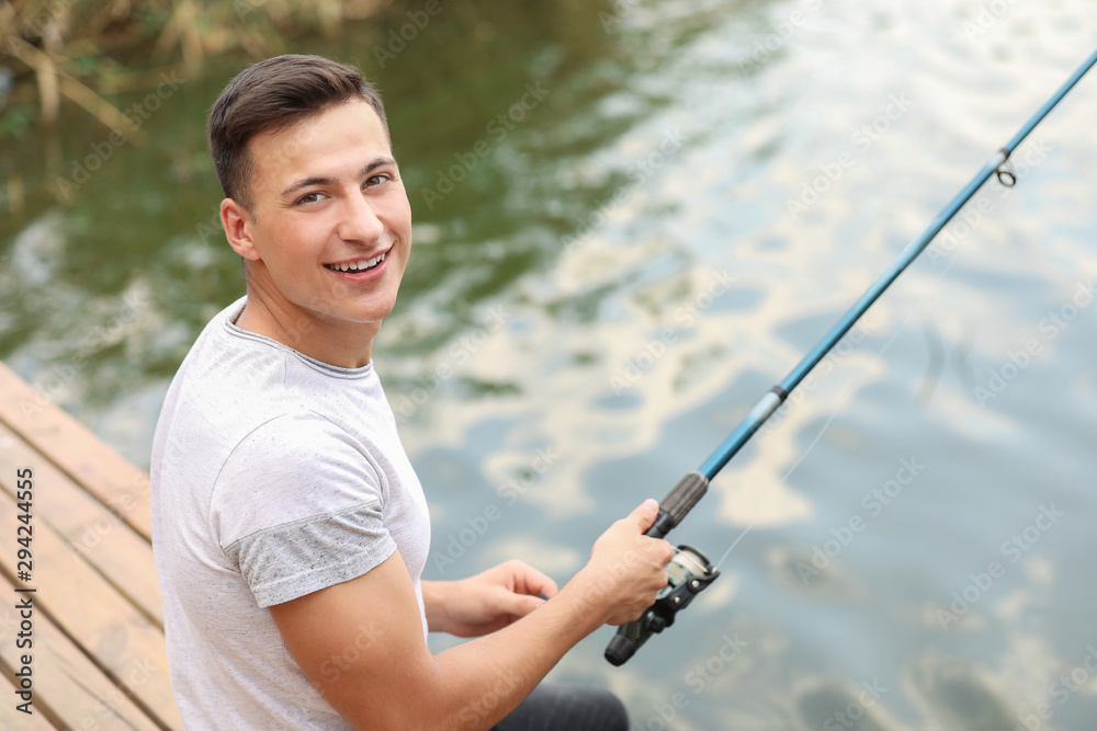 Young man fishing on river