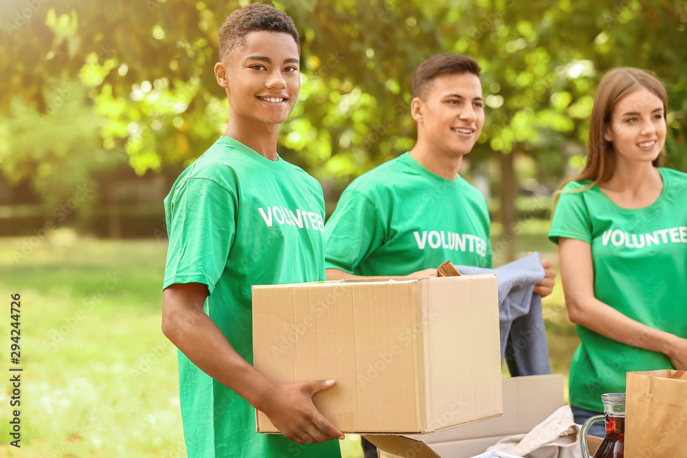 Young volunteers with donation for poor people outdoors