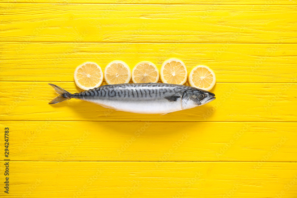Raw mackerel fish and lemon on wooden background
