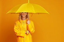 Ng Happy Emotional Girl Laughing  With Umbrella   On Colored Yellow Background.