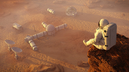 Wall Mural - astronaut on planet mars, sitting on a cliff above a research station