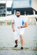 © Maksymiv Iurii - Fitness. Young man running in urban environment