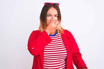 Canvas Print - young beautiful woman wearing striped t-shirt and jacket over isolated white background smelling som