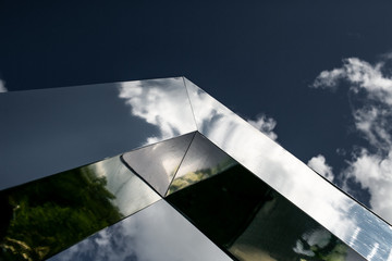 Clouds reflected in windows of modern office building