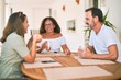 © Krakenimages.com - Beautiful family sitting on terrace drinking cup of coffee speaking and smiling