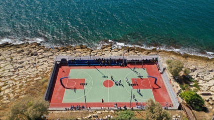 Wall Mural - Aerial top down photo of outdoor basketball court by the sea in Piraeus area, Attica, Greece