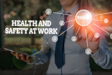 Poster - Writing note showing Health And Safety At Work. Business concept for Secure procedures prevent accidents avoid danger Woman wear formal work suit presenting presentation using smart device