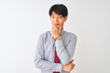 Wall Mural - Chinese businessman wearing elegant tie standing over isolated white background looking confident at the camera smiling with crossed arms and hand raised on chin. Thinking positive.