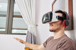 © DragonImages - Positive young man wearing VR headset when testing new application he created