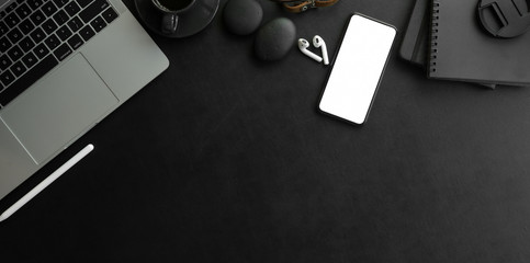 Wall Mural - overhead shot of dark modern workplace with laptop computer and office supplies