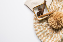 Knitted Hat And Pine Cones And Cinnamon Sticks In A Bowl On White Background. Autumn Concept
