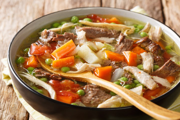 Canvas Print - Thick slowly cooked soup with vegetables and meat close-up in a plate. horizontal