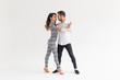 © satura_ - Passionate couple dancing social danse kizomba or bachata or semba or taraxia on white background with copy space