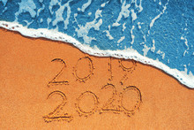Happy New Year 2020 Concept, Lettering On The Beach. Sea Sunrise