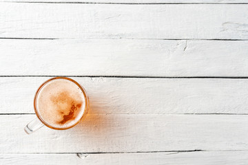 Beer mug on vintage wooden table with copyspace. Top view